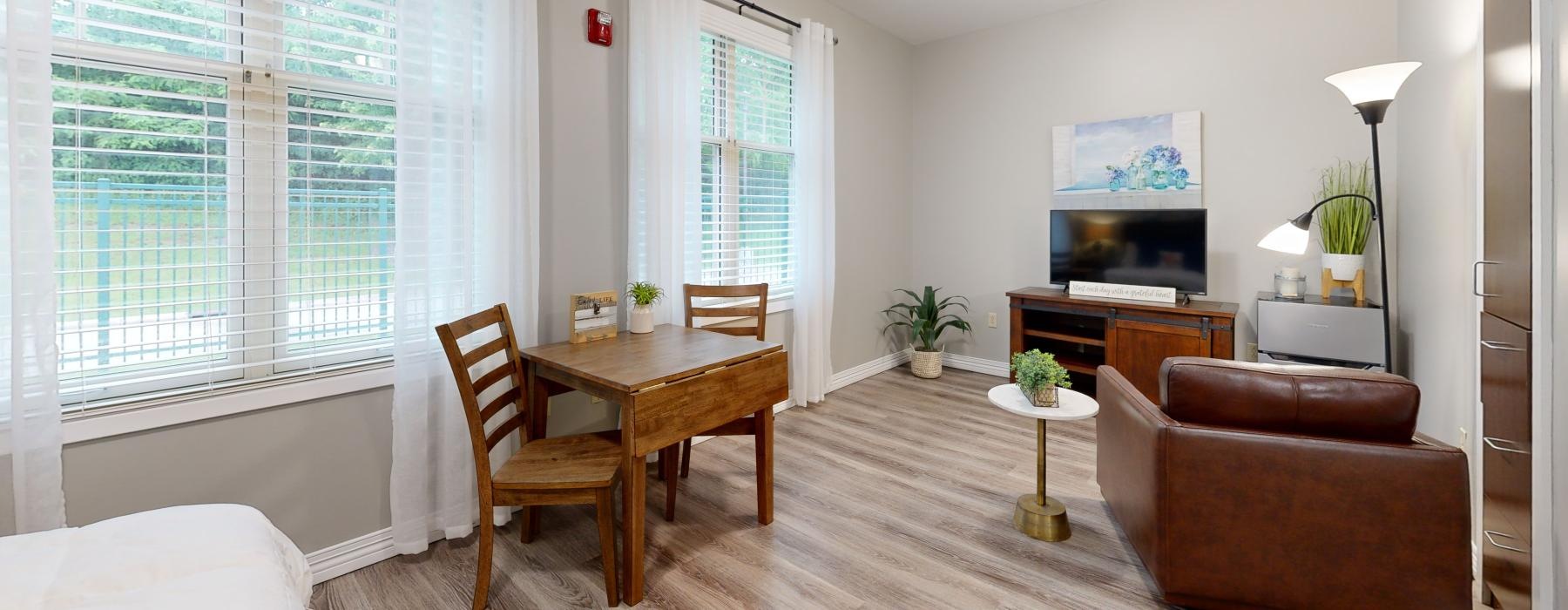 a living room with a table and chairs